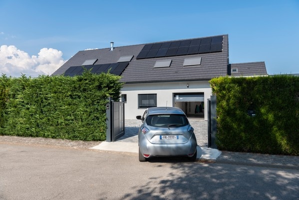 Car entering driveway with electric gates