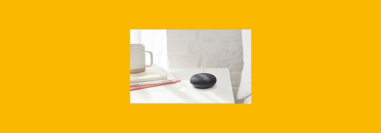 Google Nest mini on bedside table