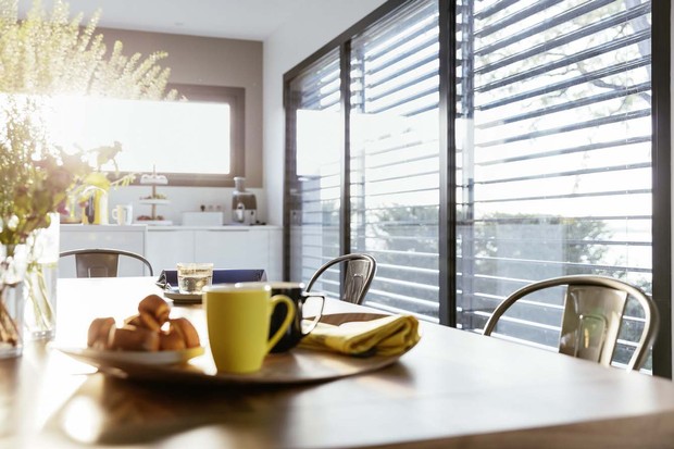 Sunlight shining through external venetian blinds