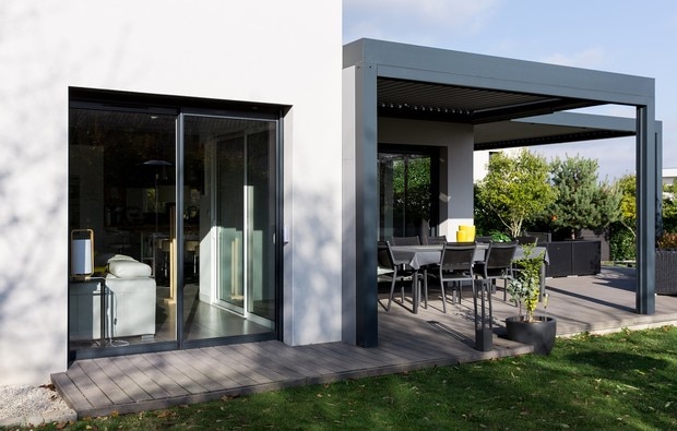 View of bare bay window and pergola covering outdoor space